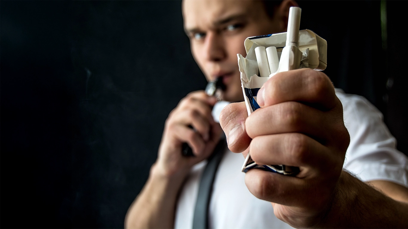 Person holding crushed cigarettes.